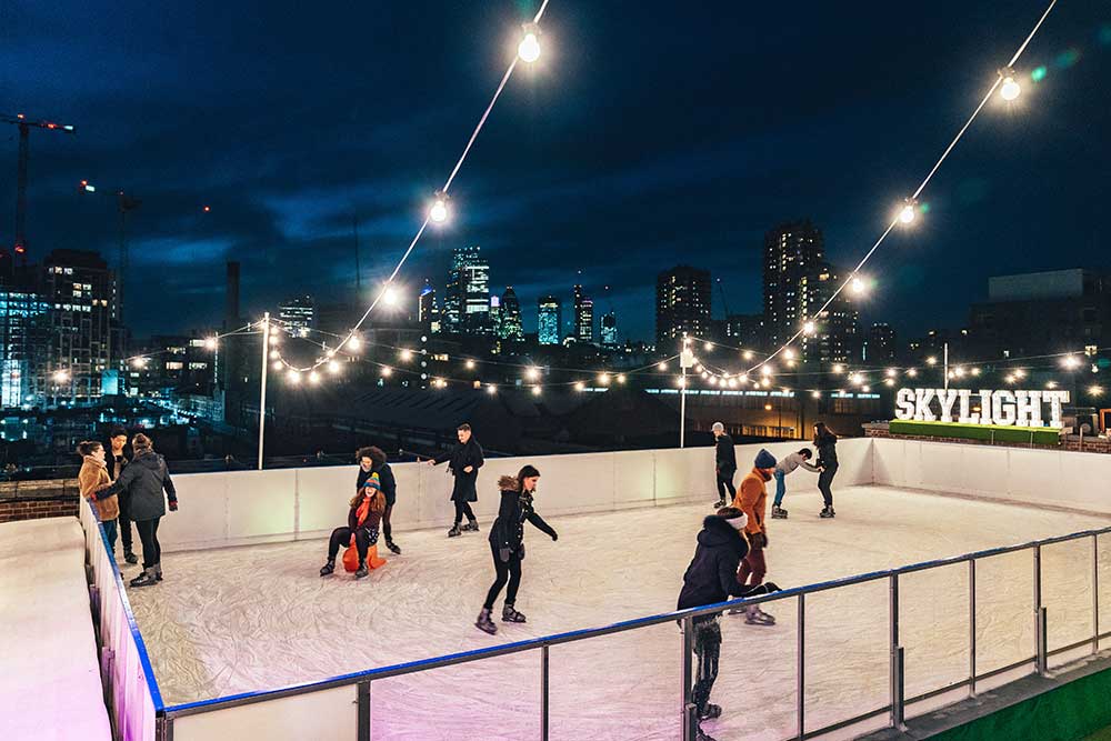 Christmas ice skating at Skylight Tobacco Dock Wapping London 2023.