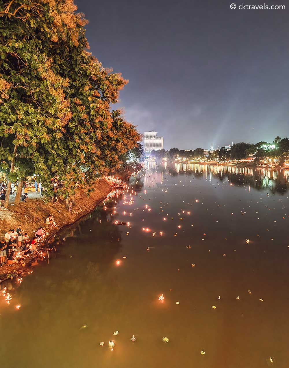 Candlelit krathongs floating down the River Ping at Loy Krathong and Chiang Mai lantern festival 